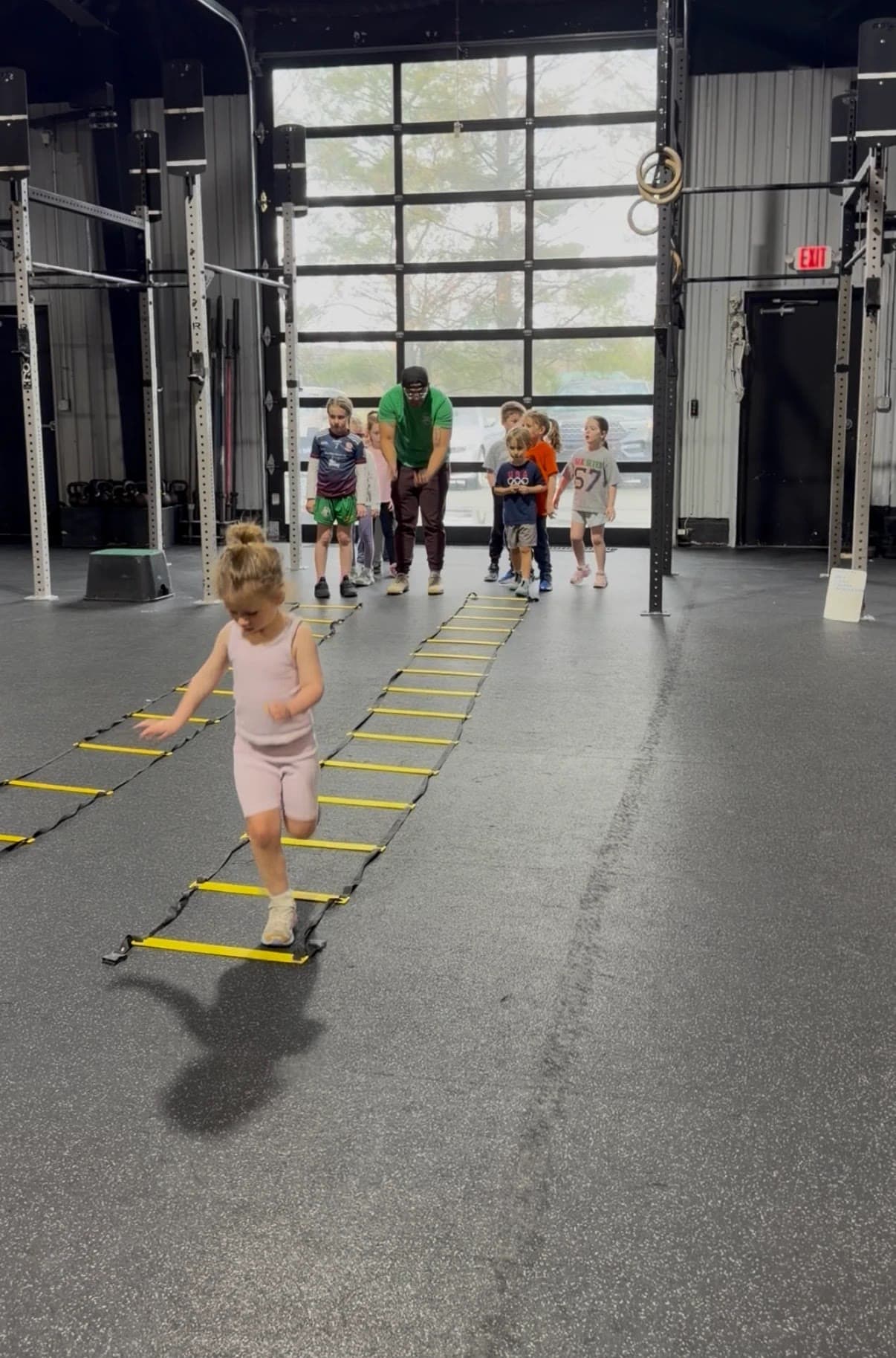 A kid running an agility ladder drill